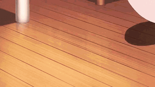 a close up of a wooden floor with a shadow on it