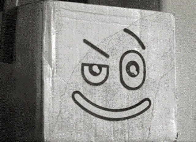 a cardboard box with a drawing of a face on it