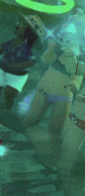 a blurry picture of a woman in a bathtub wearing sunglasses and a hat