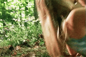 a close up of a person holding a dog 's tail in the grass .