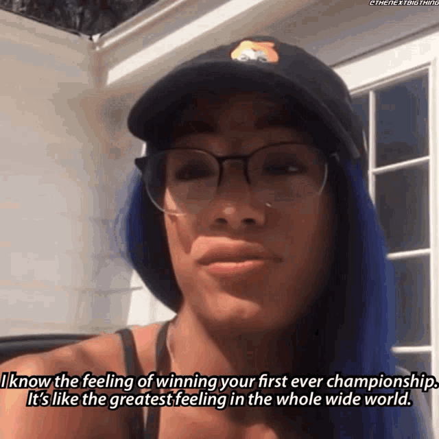 a woman wearing glasses and a hat says " i know the feeling of winning your first ever championship