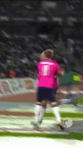 a soccer player wearing a pink jersey with the number 8