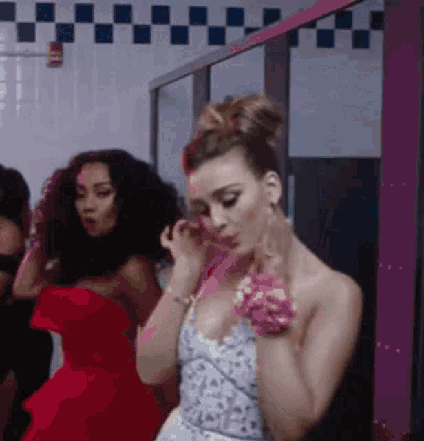 a woman in a white dress is standing in a bathroom .