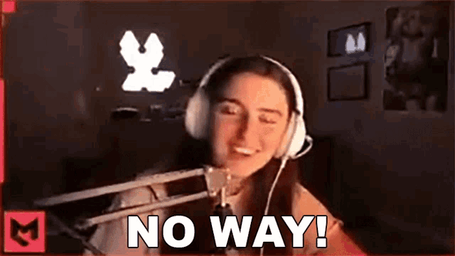 a woman wearing headphones is sitting in front of a microphone and saying `` no way ! ''
