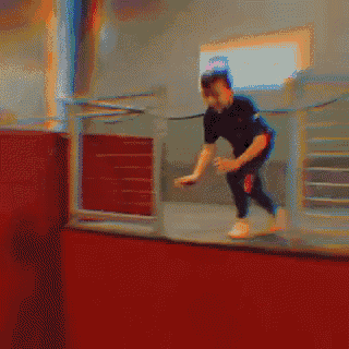 a pixelated image of a person jumping over a fence