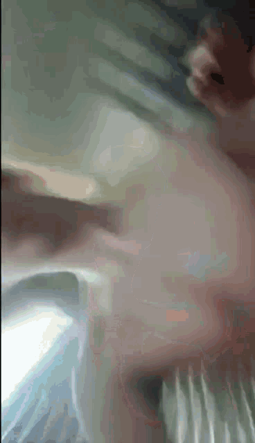 a close up of a person 's face with a blurred background .