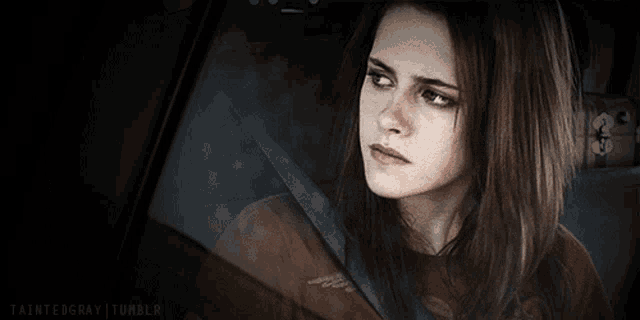 a woman sitting in a car with a taintedgray tumblr watermark