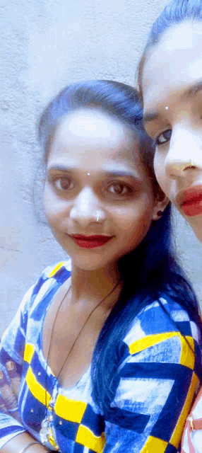 a woman with a nose ring is posing for a picture with another woman