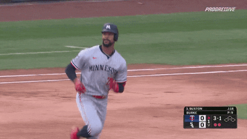a baseball player wearing a minnesota jersey runs on the field