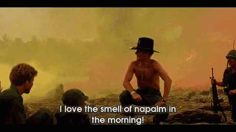 a man in a cowboy hat says " i love the smell of napalm in the morning " in a movie scene