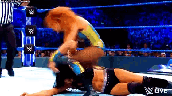 two wrestlers are wrestling in a wrestling ring with a referee and the words w live on the bottom