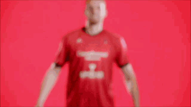a man wearing a red shirt that says ambar