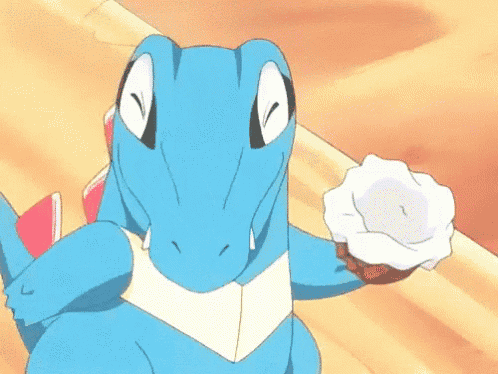 a blue cartoon dinosaur is holding a white object in its mouth .