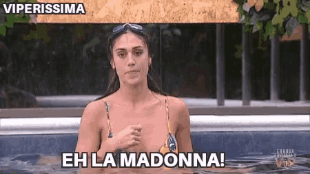 a woman in a bikini is in a hot tub and says eh la madonna !