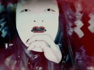 a woman with a white mask on her face has a tattoo on her hand