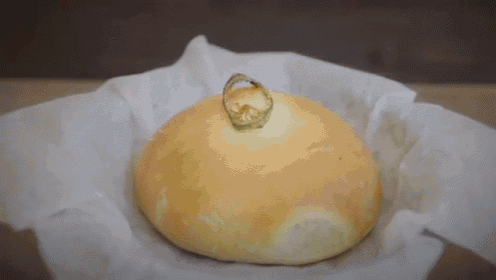a loaf of bread with a wedding ring on top