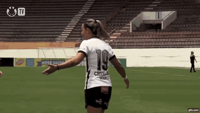 a female soccer player wearing a jersey with the number 19 on it