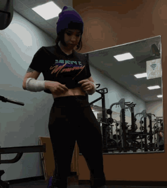 a woman in a gym wearing a shirt that says " muscle efficiency "