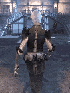 a person is standing in front of a building in a video game and looking at the camera .