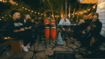a group of musicians are playing instruments including drums and saxophones