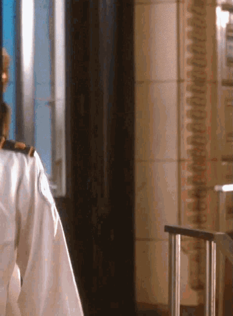 a person in a white shirt is standing in front of a door