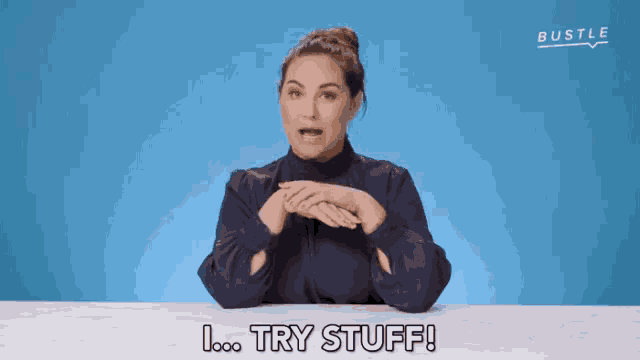 a woman sitting at a table says " try stuff "