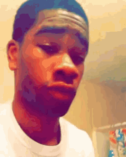 a man in a white shirt is making a face