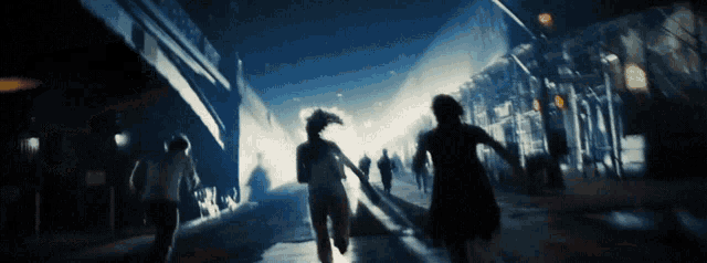 a blurry picture of people running down a street