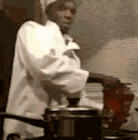 a man in a chef 's uniform is cooking in a pot