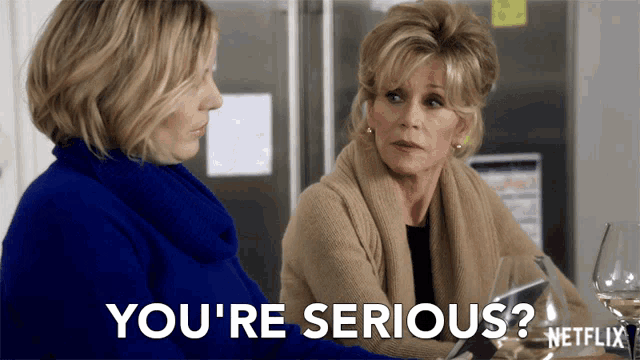 two women sitting at a table with the words " you 're serious " written in white