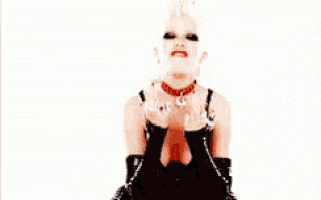 a woman in a black dress and red choker is giving the middle finger .