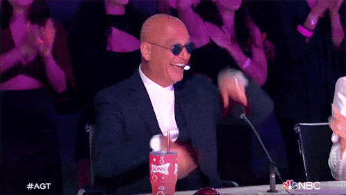 a bald man wearing sunglasses is sitting at a table with a cup of sunkist soda