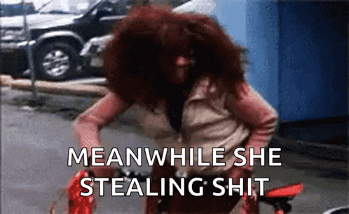 a woman with red hair is riding a bike with the words meanwhile she stealing shit below her