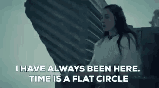 a woman is standing in front of a large rock with the words `` i have always been here . time is a flat circle ''