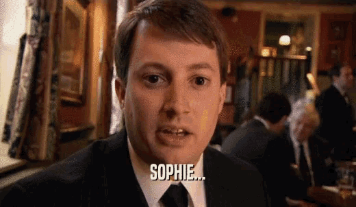 a man in a suit and tie says " sophie "