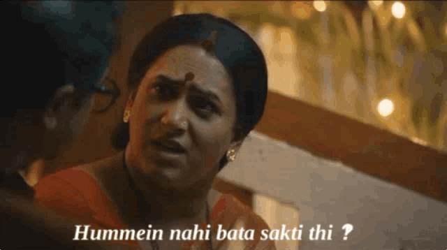 a woman in a red top is talking to a man and the words hummein nahi bata sakti thi are above her