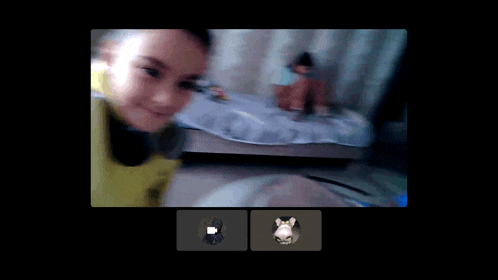 a blurred image of a child on a video call with a cat