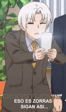 a man in a suit and tie is holding a cell phone with the words eso es zorras sigan asi below him