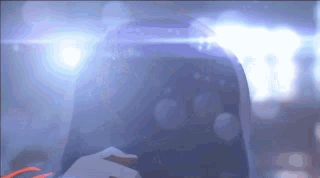 a close up of a person wearing a helmet with a light shining on it .