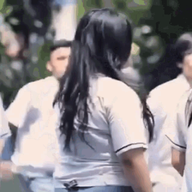 a group of people are standing next to each other in a crowd .