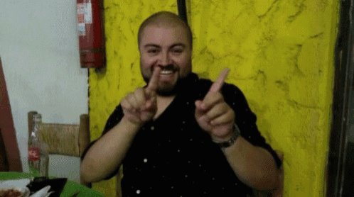 a man with a beard is giving the thumbs up sign