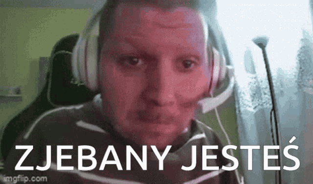 a man wearing headphones and a headset with the words zjebany jestes written on the bottom