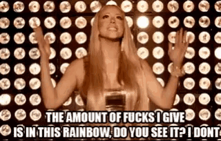 a woman is standing in front of a wall of lights and says the amount of fucks i give