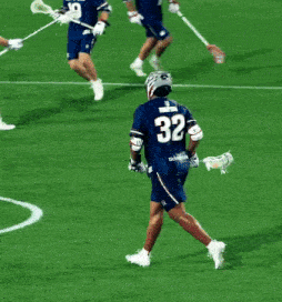 a lacrosse player with the number 32 on the back of his shirt