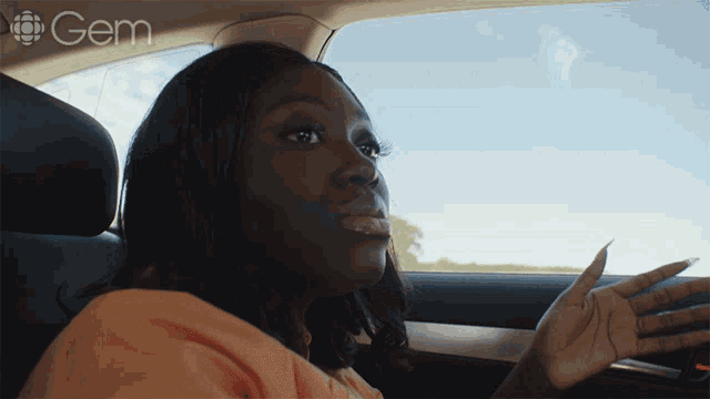 a woman in a car with the word gem on the bottom left