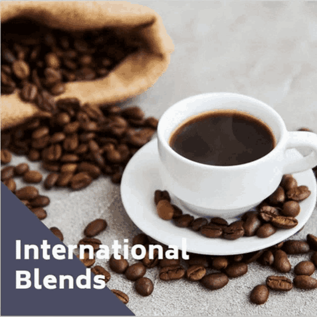 a cup of coffee on a saucer surrounded by coffee beans and the words international blends