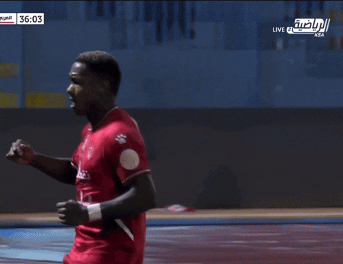 a soccer player in a red jersey celebrates a goal during a live broadcast