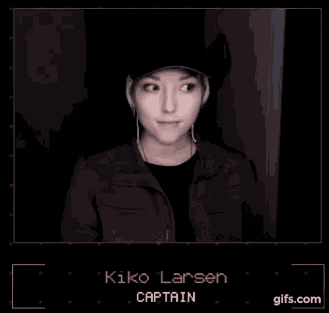 a woman wearing a hat and headphones is giving the middle finger