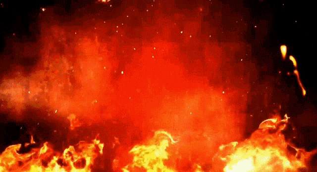 a large fire with lots of flames and smoke coming out of it