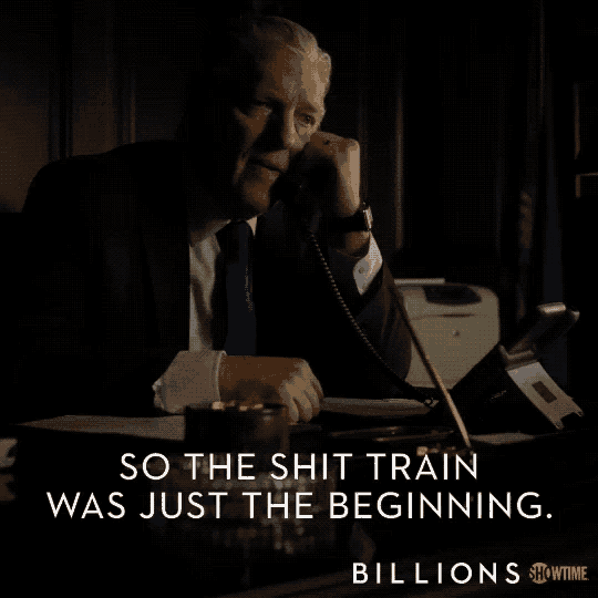 a man in a suit and tie is talking on a phone with the words so the shit train was just the beginning below him